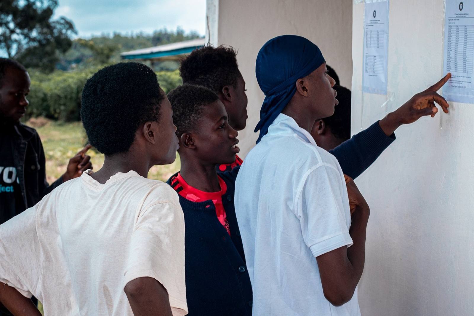 Students reading results on a wall